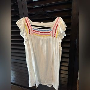 L love white top with open back and ribbon.